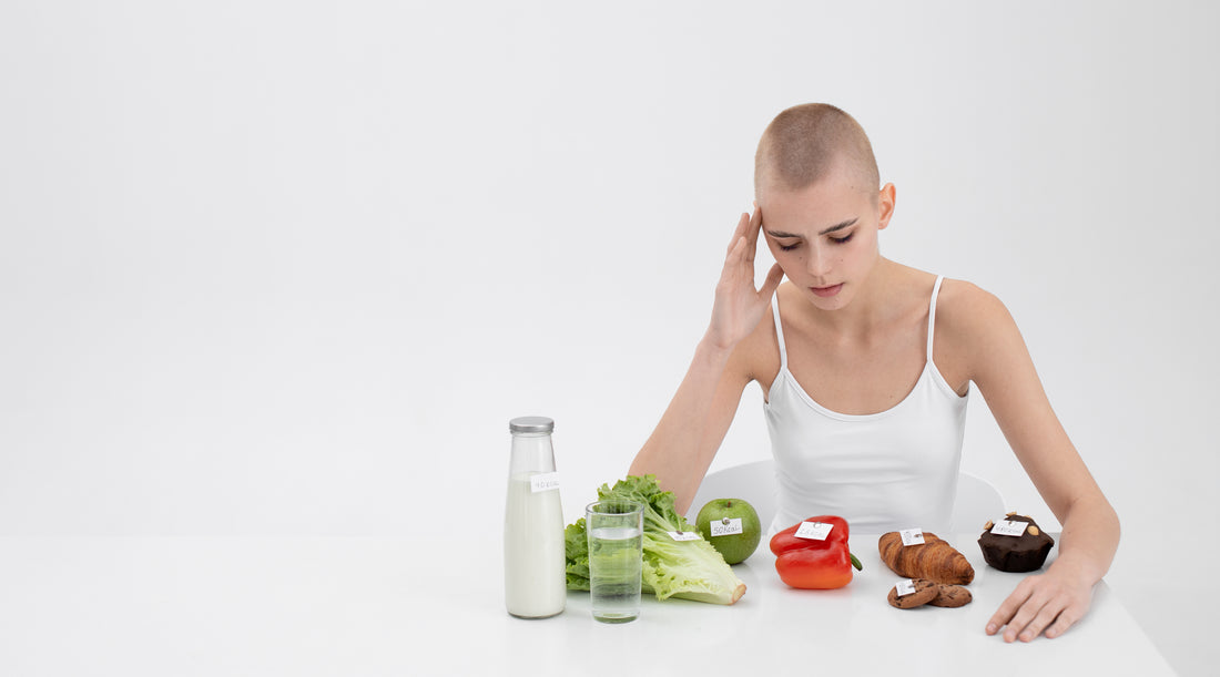 A bald woman sits at a table, holding a bowl of vegetables, while Vitamin C Gummies: Bridging Nutritional Deficiencies is displayed in the background