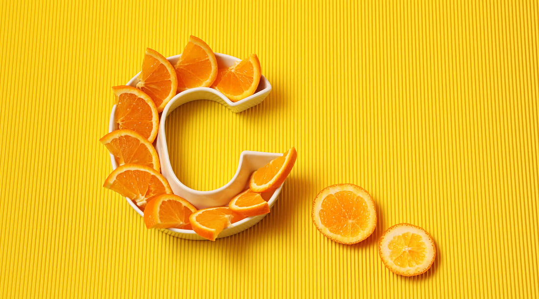 Oranges arranged in the shape of the letter C on a yellow background, advertising vitamin C gummies